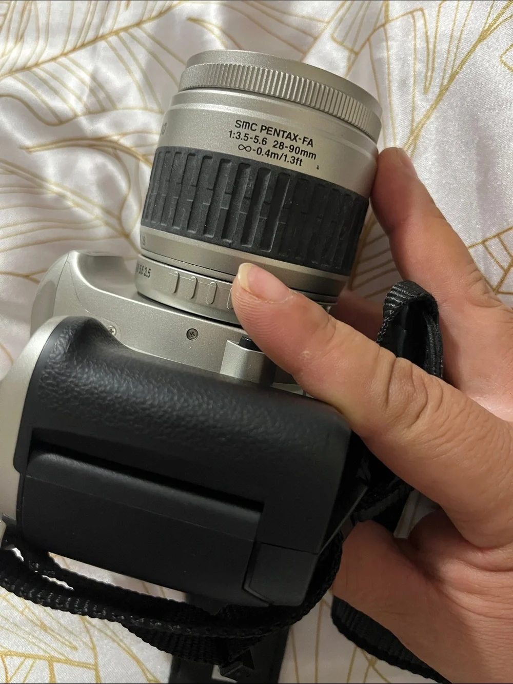 Pentax Silver and Black DSLR with 28-90mm Zoom Lens and Branded Strap